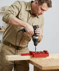 Man using Self Centering Doweling Jig Kit For Woodworking Joinery With 6mm 8mm 10mm Dowel Holes on a wooden board.