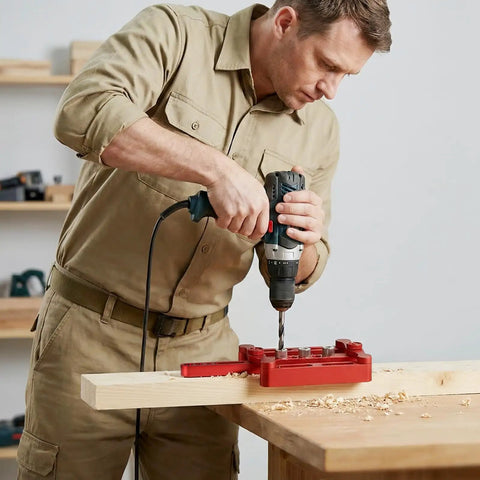 Man using Self Centering Doweling Jig Kit For Woodworking Joinery With 6mm 8mm 10mm Dowel Holes on a wooden board.