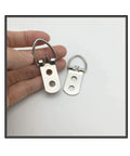 Heavy Duty D Ring Steel Picture Hangers With Screws 20 Pack Double Hole Clips shown in hand for size reference, silver color