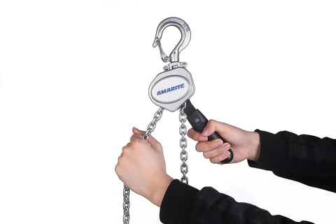 Hands operating Compact Half Ton Chain Lever Hoist Come Along with 1100 lbs capacity and 10 ft lift chain, showing forged hook.