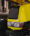 Close-up of bright yellow front loader on Construction Pedal Tractor With Front Loader And Detachable Trailer For Kids Ages 2.5 And Up