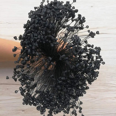 No Fancy Tools Needed Five Inch Black Plastic Hang Tag Fasteners One Thousand Pack in hand with multiple black security pins.