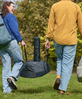 People carrying Karu 12 and Karu 2 Carry Cover Waterproof Weatherproof Shield For Pizza Ovens On The Go Grilling Grab And Go Ready.