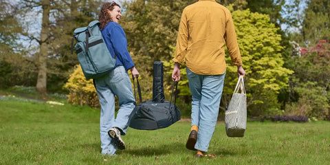 People carrying Karu 12 and Karu 2 Carry Cover Waterproof Weatherproof Shield For Pizza Ovens On The Go Grilling Grab And Go Ready.