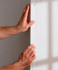 Hands applying drywall corner bead using drywall corner bead spray adhesive 13.8 oz can, contractor-grade fast-grab aerosol.