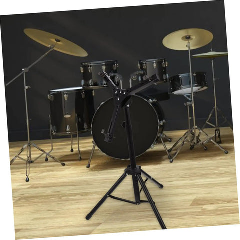 Solid Height Adjustable Snare Drum Stand Portable Alloy Tripod Practice Rack in front of a drum set on a wooden floor.
