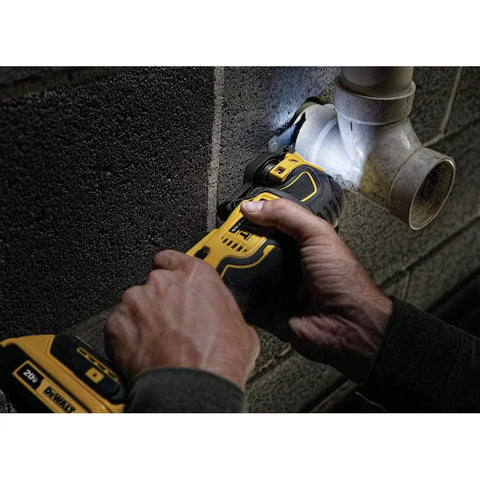 Person using Atomic 20V Max Cordless Oscillating Tool Bare Tool With Brushless Motor Dual Grip Variable Speed Trigger for pipe cutting