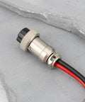 Close-up of Two Pin Core Radio Power Cable 1.2 Meter Long 12 V DC Lead for Kenwood TR 7400 VHF Transceiver on concrete surface.