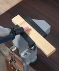 Beast Mode Aluminum Bench Vise For Electric Drill 44mm To 58mm Jaw Opens 360 Degree Swivel Stand holding wood during polishing.