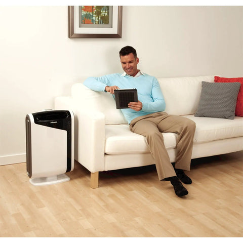 Man on sofa near AeraMax 200 with Authentic Carbon Replacement Filters 4 Pack For AeraMax 200 Air Purifier Odor And VOC Removal
