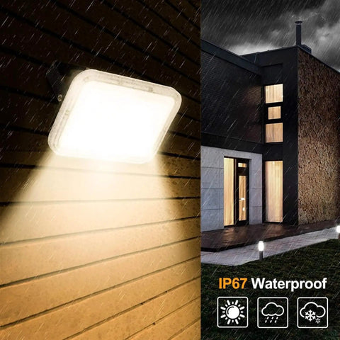JUDYSSY Led Flood Lights Outdoor 30W mounted on a wall, illuminating rain-soaked surface, showcasing IP67 Waterproof feature.