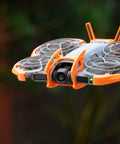 Drone Protection Accessories Kit For DJI Neo 2 Restores Flight Safety With Propeller Guards, shown in flight with orange guards.