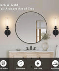 SANTOSTOCK Black Wall Sconces Set of Two with clear glass shades installed on bathroom wall next to round mirror.