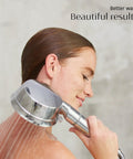 Woman using Handheld Chrome Shower Head With Chlorine And Mineral Filter, Adjustable 7-Setting Spray, sleek bathroom setting