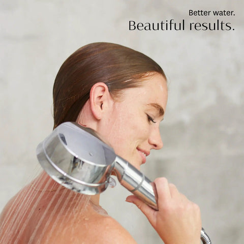 Woman using Handheld Chrome Shower Head With Chlorine And Mineral Filter, Adjustable 7-Setting Spray, sleek bathroom setting