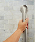 Hand holding a 24 Inch Stainless Steel Handicap Grab Bar For Bathtub And Shower With Slip Resistant Peened Texture, Supports Up To 500 Lbs