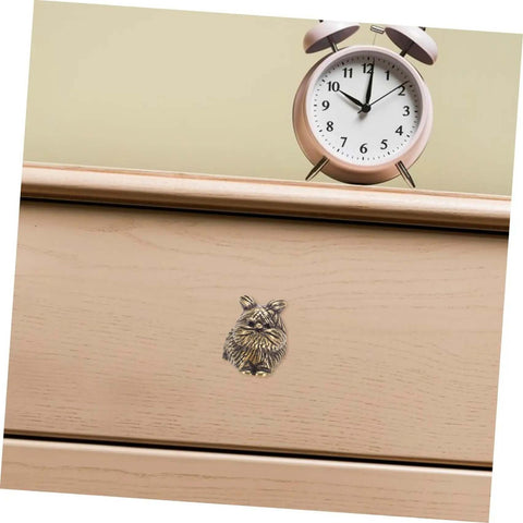 Cat Shaped Brass Cabinet Knobs Set For Kitchen Bedroom And Bath on wooden drawer with clock on top