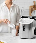 Crunchy Nugget Ice Maker For Countertop With Auto Cleaning 35 Lbs Per Day Portable Sonic Ice Machine with woman scooping ice.
