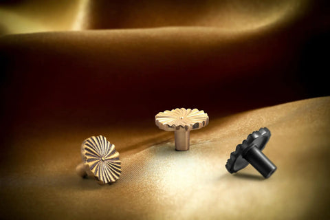 6 Pack Zinc Alloy Drawer Knobs Champagne Bronze With Flower Design on textured fabric, angled view