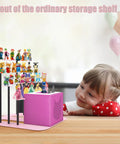 Ultimate Pink Metal Toniebox Stash Holder For 20 To 35 Tonies With Premium Magnetic Shelf desk stand with toys and child smiling.