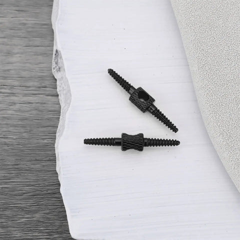 Two black Ten Pack 26mm Bicycle Cable Connectors for Brake and Shift Cables, 2mm aperture, shown on a textured surface.