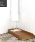 17-Inch Downspout Splash Block And Gutter Extender Kit placed under a gutter to prevent erosion, showing water flow, brown color.