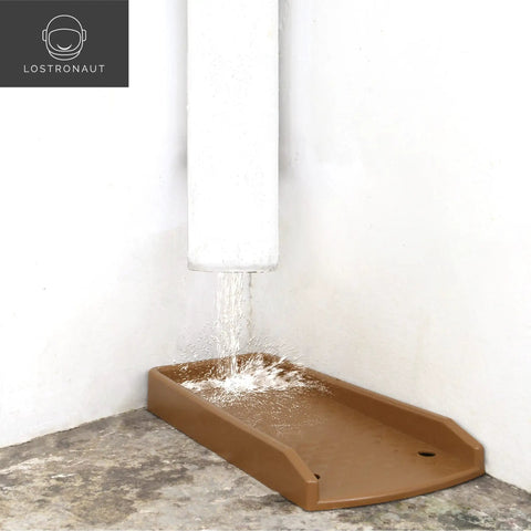 17-Inch Downspout Splash Block And Gutter Extender Kit placed under a gutter to prevent erosion, showing water flow, brown color.