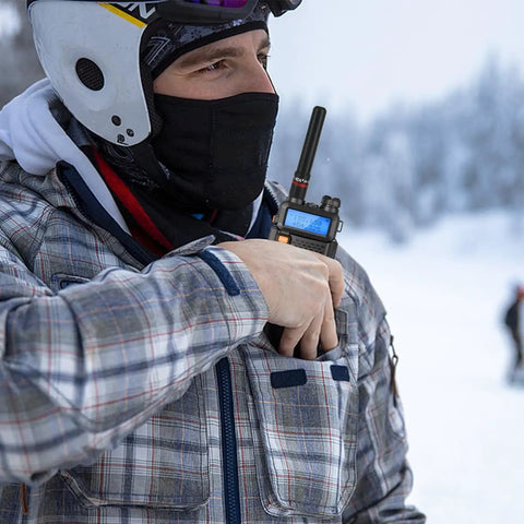Person using radio with 3.14-Inch Stubby Dual Band Antenna For VHF UHF 144/430MHz, SMA Female Connector, outdoors in snow.