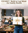 Family gathering at a dining table with a woman holding a gift box, kitchen in the background, promoting Guanci for family health.