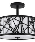 Black modern ceiling light fixture with abstract metal design, featuring a frosted white drum shade, suitable for contemporary interiors.