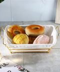 Gold Wire Serving Basket For Fruit And Bread with linen liner holding assorted breads on a kitchen counter