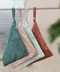 Four Two Pack Wet Dry Bags On The Go For Travel Pool Beach Gym And Baby Gear in different colors hanging near a window