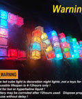Light Up LED Ice Cubes For Drinks, 120 Pack Waterproof Multi Color Glow With Liquid Sensor spelling 'LAL' on dark surface