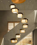 Massive Staircase Chandelier With Eight Bamboo Shades And Long Adjustable Drop serving serious retro country vibes in a stylish entryway.