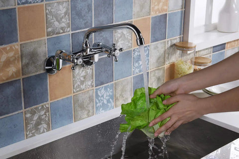 Wall Mount Kitchen Faucet With Adjustable 3 To 9 Inch Spread, 2 Cross Handles, Chrome Finish, 1.8 GPM Flow in use over sink