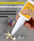 Hand holding jewelry repair adhesive with nozzle near rings and earrings, showcasing transparent glue for metal and gemstone repairs.