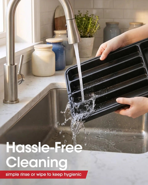 Expandable Silverware Drawer Organizer being rinsed in kitchen sink for cleaning. Adjustable utensil tray in black medium size.