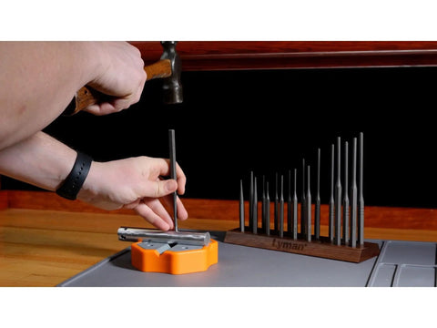 Using Dead Nuts Solid 18 Piece Hex Punch Set With Hardened Steel Bodies on a workbench for precision tasks.