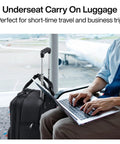 Hanke 16-inch underseat carry-on luggage with wheels, black softside, beside traveler using laptop at airport.