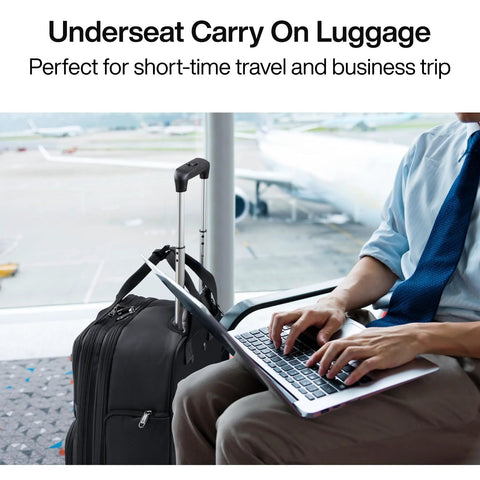 Hanke 16-inch underseat carry-on luggage with wheels, black softside, beside traveler using laptop at airport.