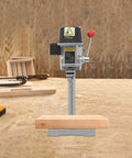 Sturdy Mini Bench Drill Press For Woodworking And Metal Crafting on a workbench with wooden base and tools in background.