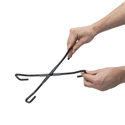 Hands holding the Badass Heavy Duty Dutch Oven Lid Lifter And Compact Folding Stand for safe lid handling.
