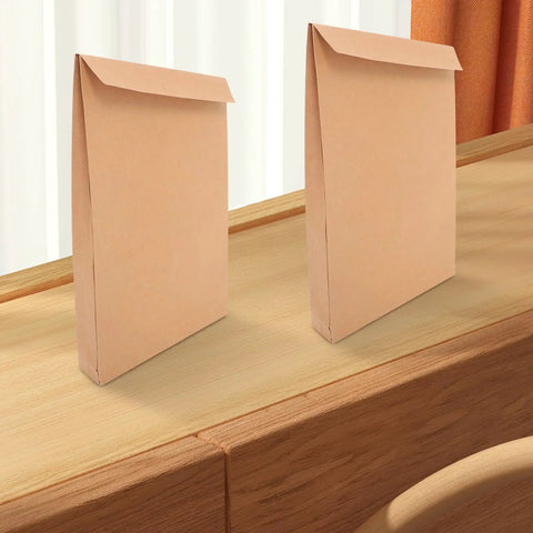 Two Kraft Mailing Envelopes 10 Pack With Double Sided Adhesive Seal on a wooden surface, 238x335x40mm, for documents and clothes