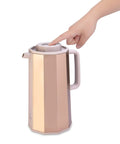 Hand pressing lid of Gold Glass Vacuum Carafe 1.0 Liter Insulated Bottle With Premium Borosilicate Glass Liner, decagonal design