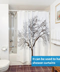 Bathroom with shower curtain featuring a tree design.