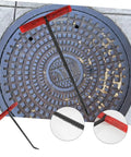 Rock Solid T Shaped Manhole Cover Lifter Hook Forged From Reinforced Steel Rod With A No Slip Grip For Reaching Down Into Deep Sewers And Yanking Open Heavy Roller Doors on a manhole.