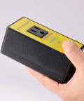 Kickstart Your Shop Setup With This Wireless Remote Automatic Vacuum Switch For 120V Dust Collectors Featuring Auto Power On Off Outlet Dual Remotes And Smart 5 To 10 Second Timer held in hand showing black body and yellow label.