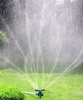 Rotating 360 Degree Lawn Sprinkler For Yard Coverage Up To 2000 Sq Ft With Auto Watering System spraying water on lawn