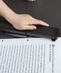 Person using Three Hole Punch For Home Office With Easy Clean Tray Punches Up To 10 Sheets At Once Durable Metal Construction Sleek Black Finish