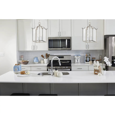 Whitmore 2-Light Chandelier in Brushed Nickel With Clear Glass Panels over a modern white kitchen island, modern vintage foyer fixture
